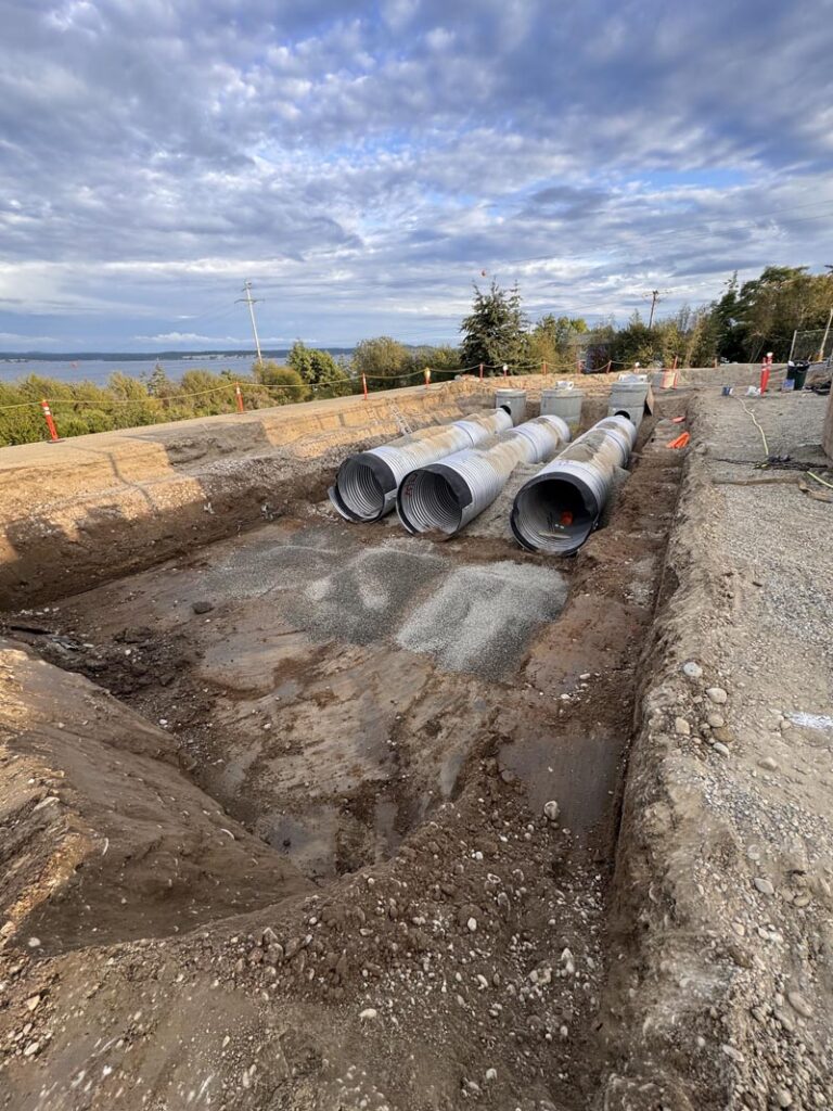 Compacting the dirt around the storm detention vault pipes