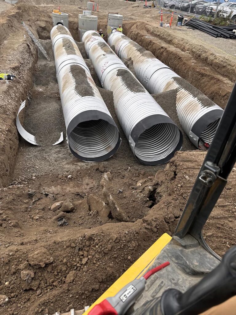 Preparing the Backfill of dirt over the detention vault pipes