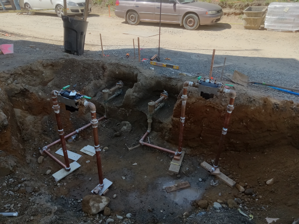 Underground plumbing installation at construction site