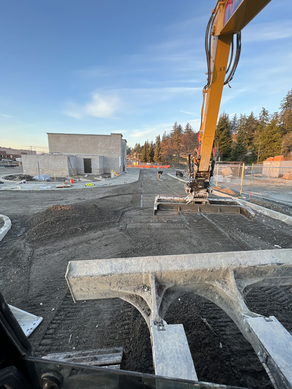 Excavator at sunset on new construction site