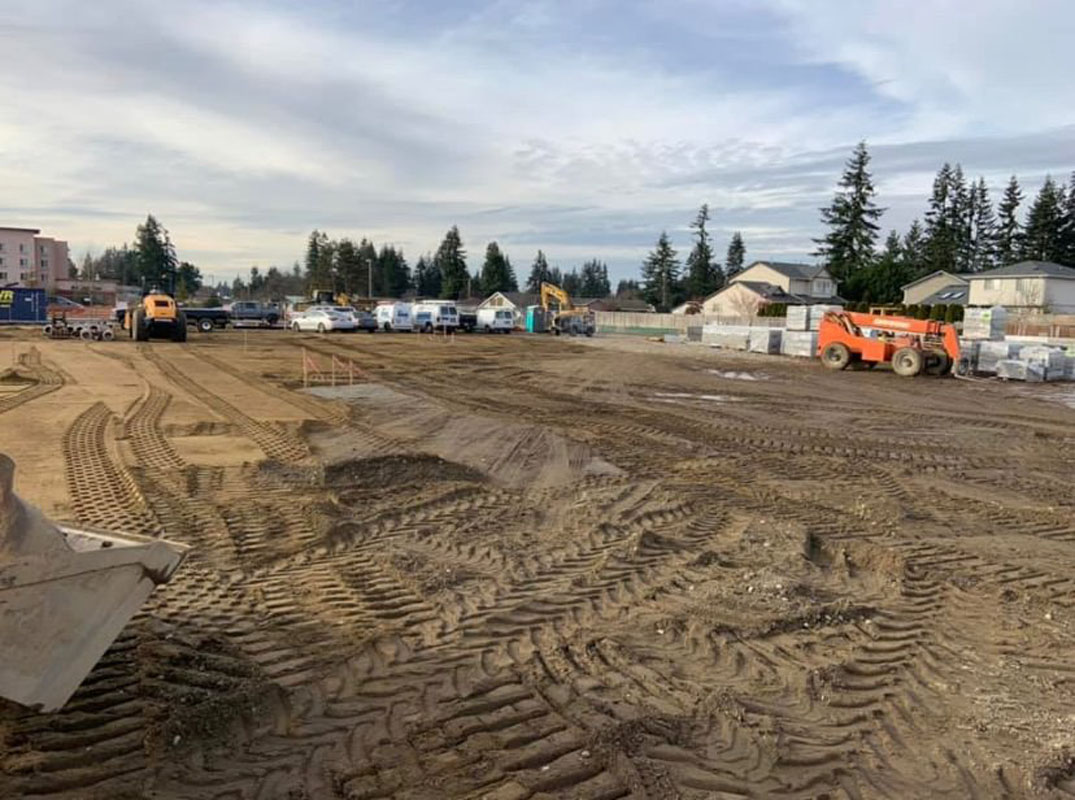 Active construction site with machinery and materials.